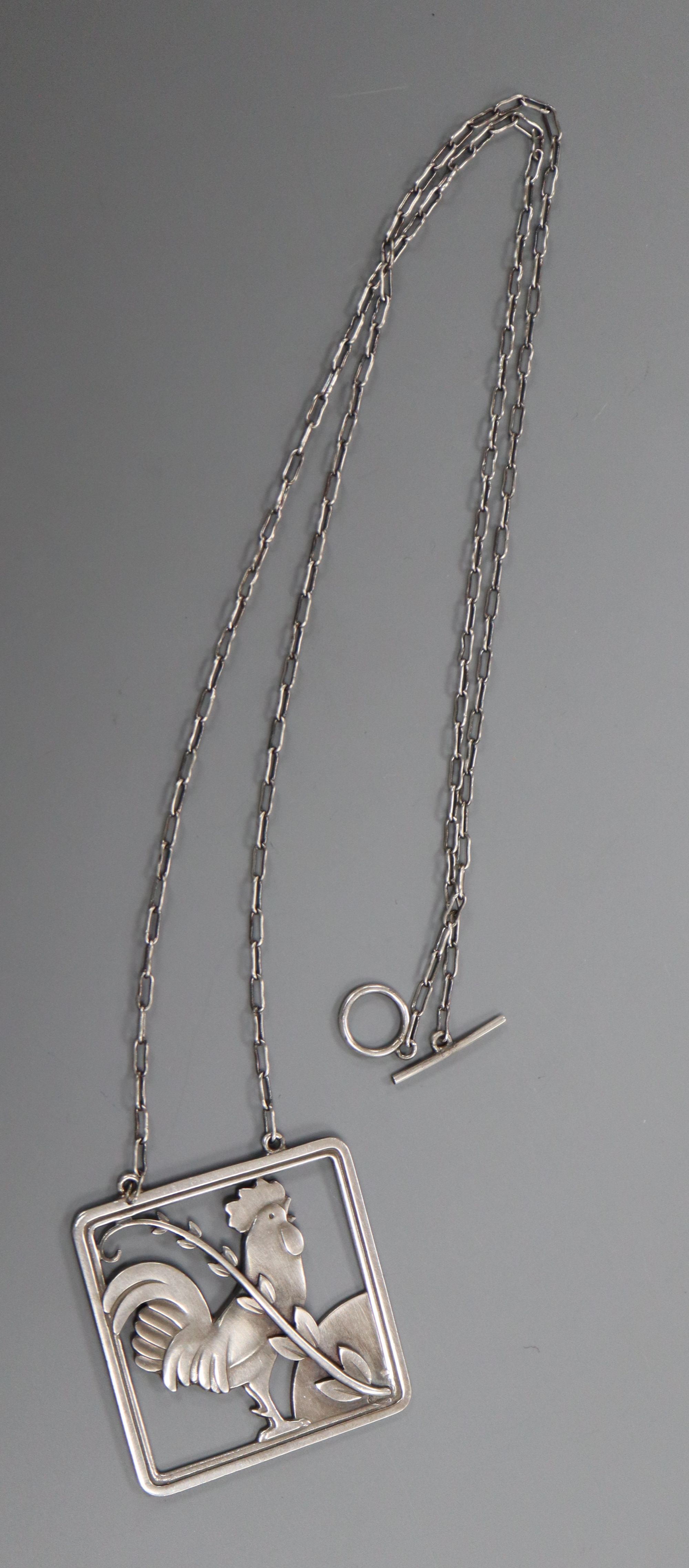 A Georg Jensen sterling Cockerel and foliate spray square pendant on chain, no. 96, pendant 38mm.